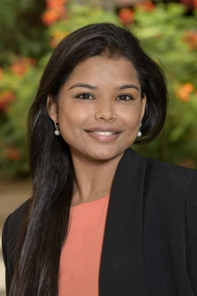 [Sangeetha Murugapandian, MBBS - dark-haired woman wearing black blazer and salmon-colored blouse]