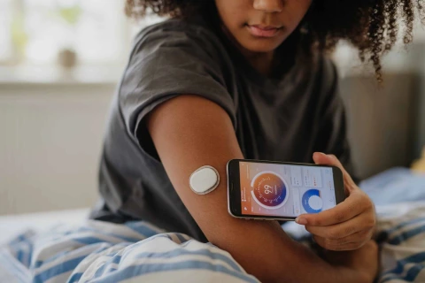 Person using a smart phone to obtain biometrics